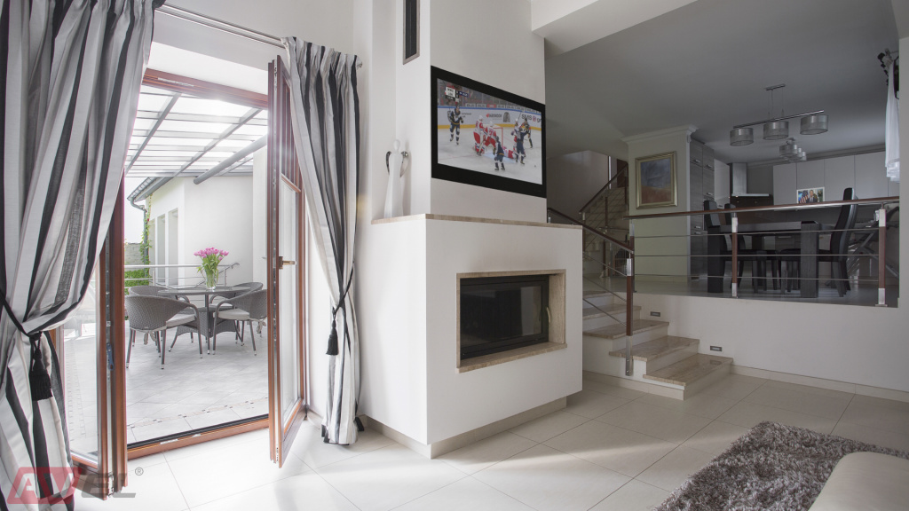 TVs above the fireplace in the interior